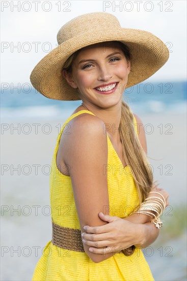 Caucasian woman wearing sun hat on beach
