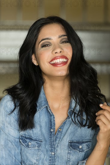 Glamorous Hispanic woman wearing lipstick