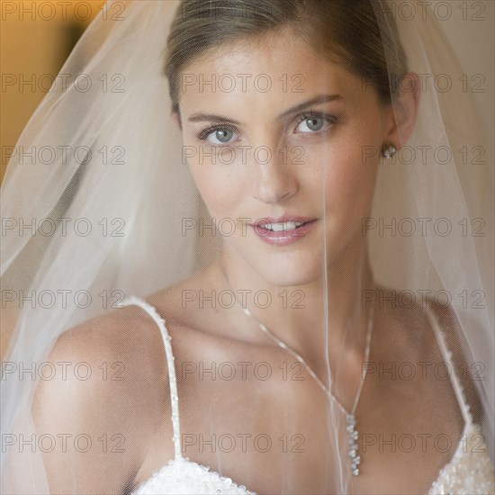 Caucasian bride wearing wedding gown and veil
