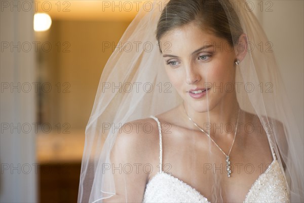 Caucasian bride wearing wedding gown and veil