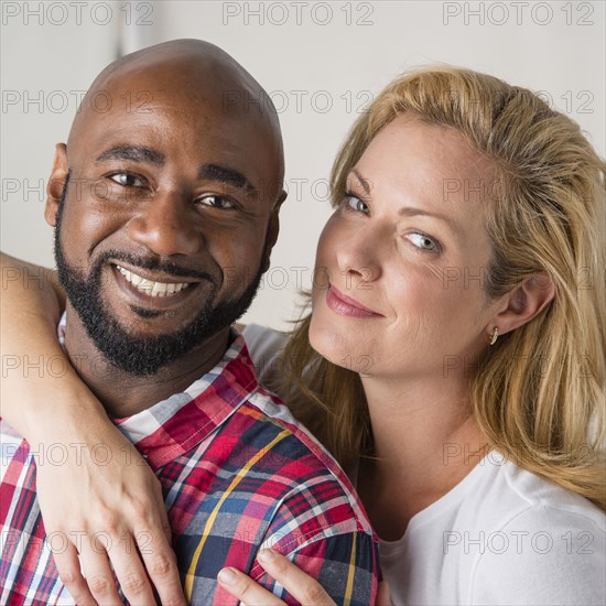 Close up of smiling couple hugging