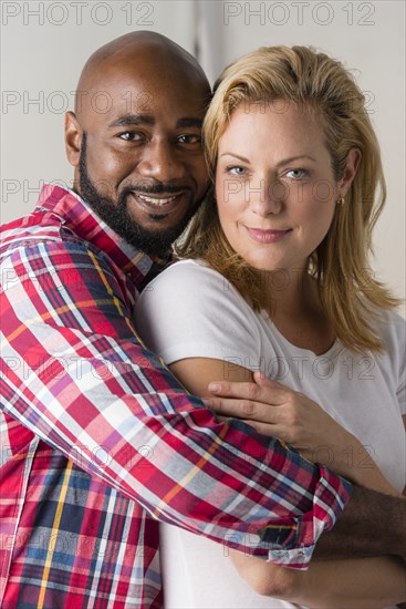 Close up of smiling couple hugging