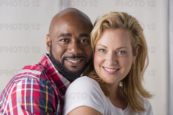 Close up of smiling couple hugging