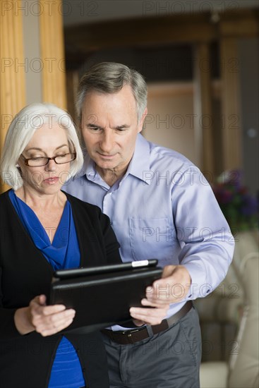 Caucasian couple using digital tablet