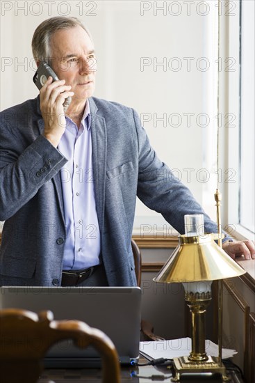 Caucasian businessman looking out office window