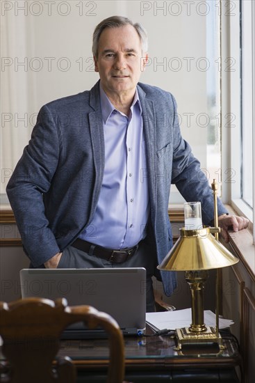 Caucasian businessman standing at office desk