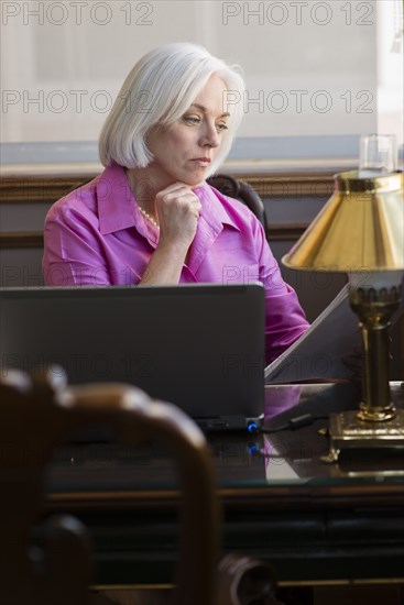Caucasian businesswoman working at office desk
