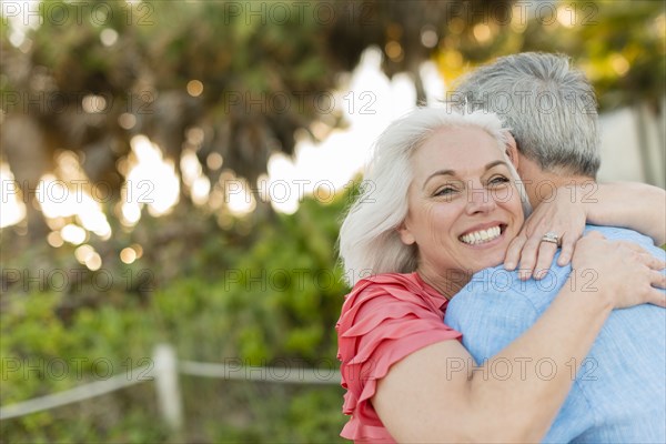 Close up of older Caucasian couple hugging