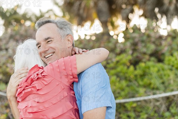 Close up of older Caucasian couple hugging