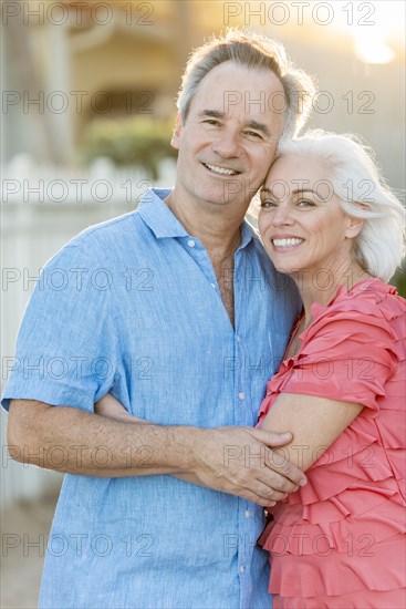 Older Caucasian couple walking on beach