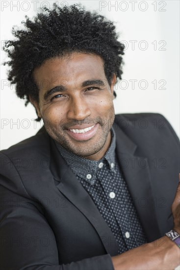 Close up of smiling Hispanic businessman