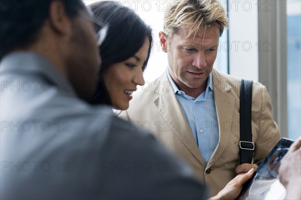 Business people using digital tablet in office