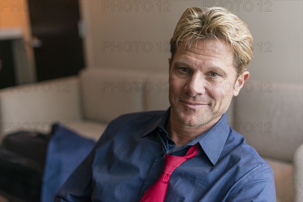 Caucasian businessman sitting in office lobby