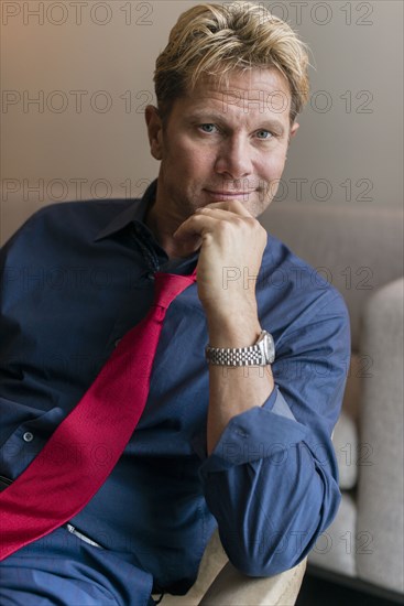 Caucasian businessman sitting in office lobby