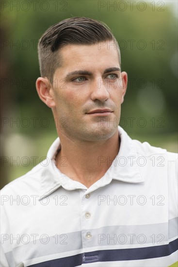 Serious Caucasian man standing outdoors