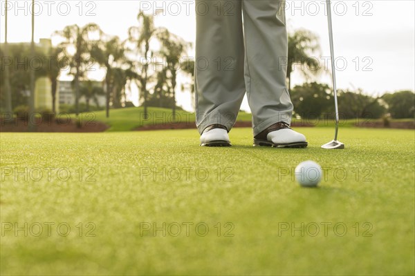 Caucasian man standing on golf course green