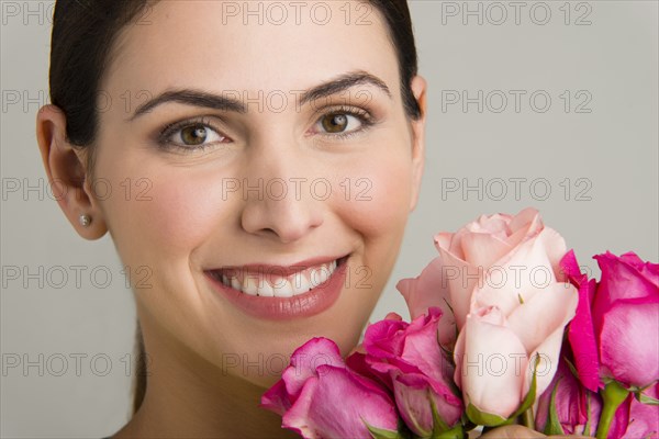 Hispanic woman holding bouquet of flowers