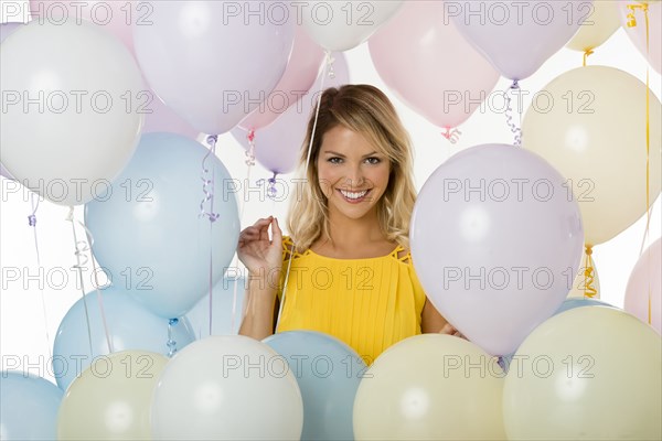 Caucasian woman standing with balloons
