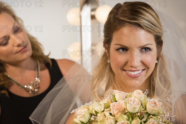 Close up of bride and maid of honor smiling