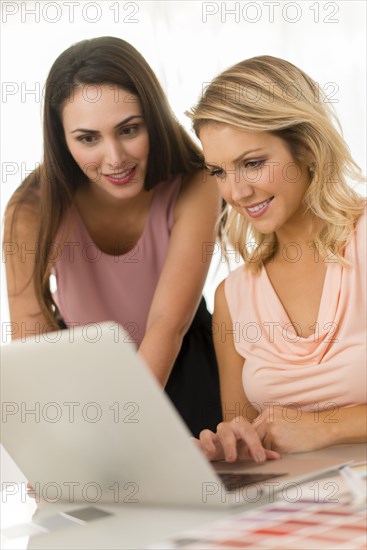 Businesswomen using laptop on table