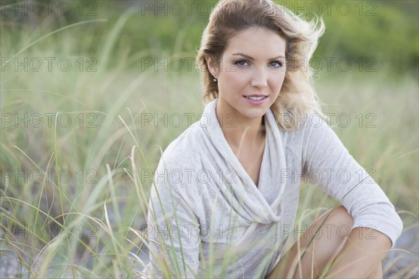 Caucasian woman sitting on beach