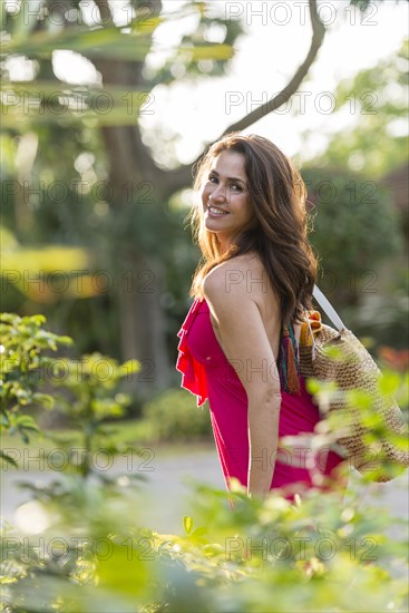 Hispanic woman carrying purse outdoors