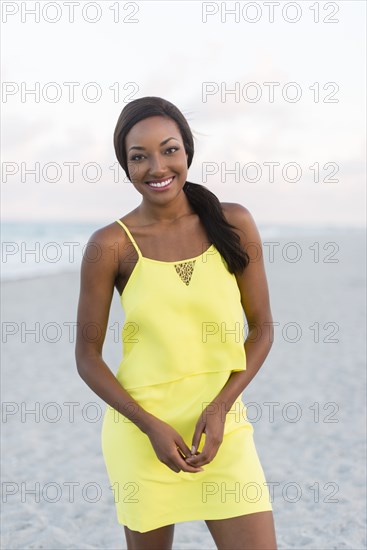 Black woman smiling on beach