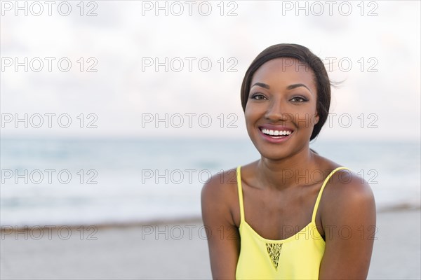 Black woman smiling on beach