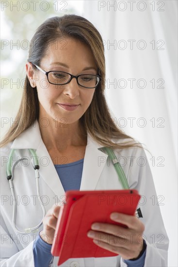 Caucasian doctor using digital tablet