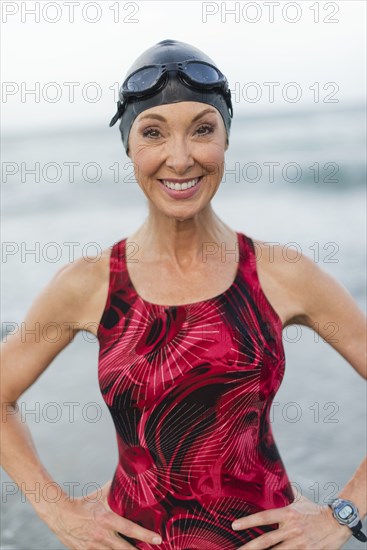 Caucasian swimmer smiling on beach
