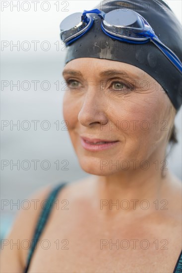 Caucasian swimmer wearing goggles and swimming cap