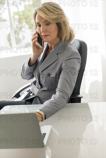 Caucasian businesswoman talking on cell phone