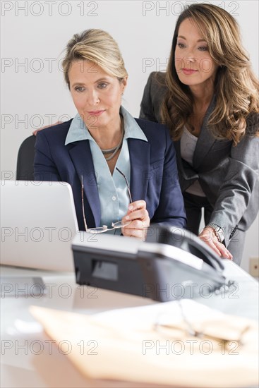 Caucasian businesswomen using laptop