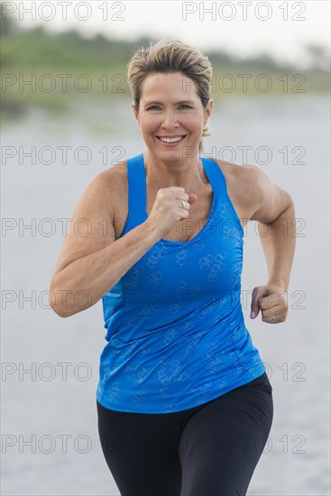 Caucasian woman running on beach