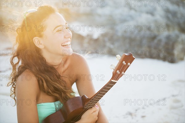 Hispanic teenage girl holding ukulele