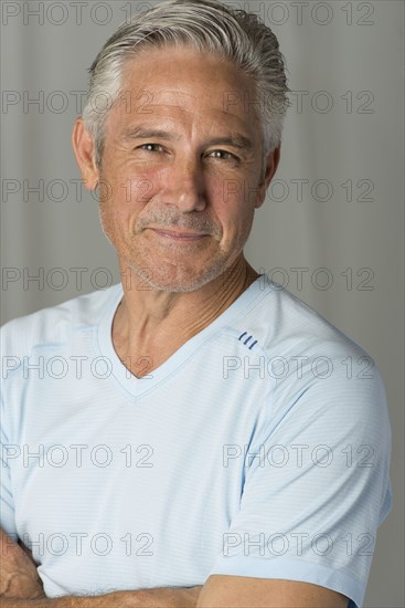Caucasian man smiling with arms crossed