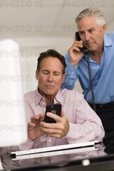 Caucasian businessmen working at desk