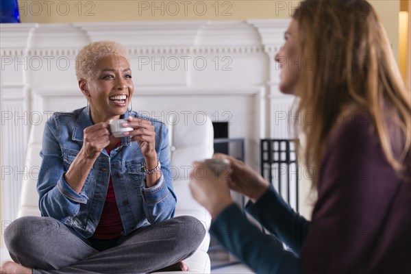 Women drinking coffee in living room