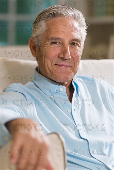 Caucasian businessman smiling on sofa