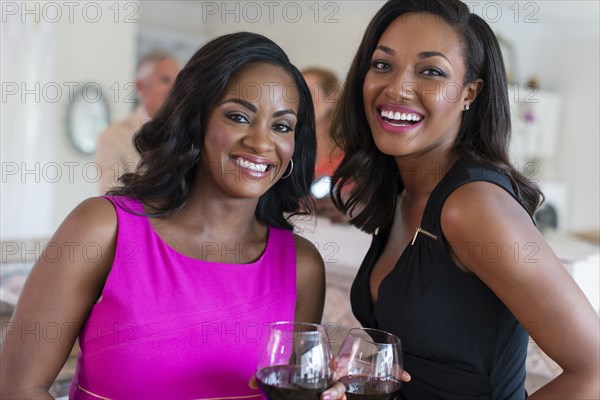 Women drinking wine at party