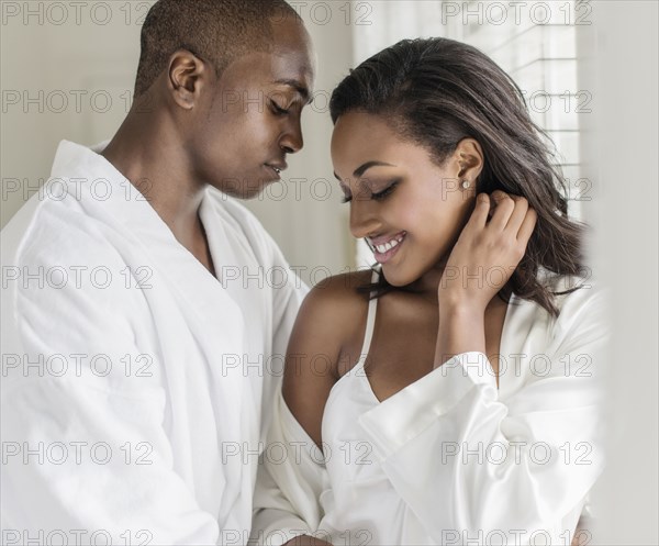 Couple hugging at window