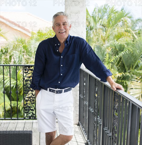 Caucasian man smiling on patio