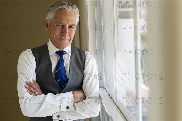 Caucasian businessman standing at window