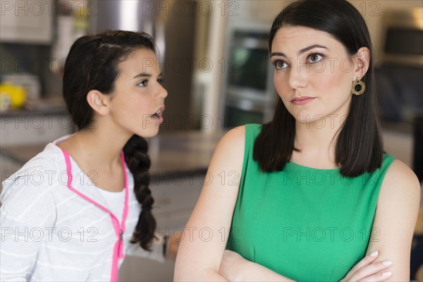 Mother and daughter arguing in kitchen