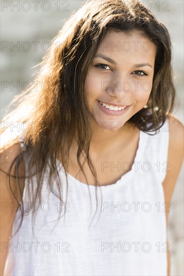 Mixed race teenage girl smiling outdoors