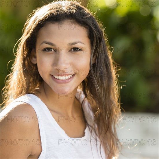 Mixed race teenage girl smiling outdoors