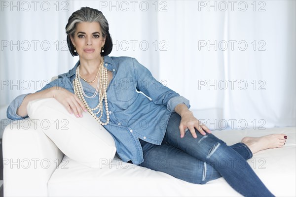 Caucasian woman laying on sofa