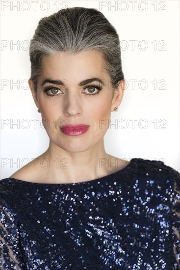 Serious Caucasian woman in sparkling gown