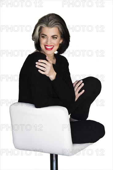 Caucasian woman sitting on stool