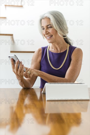 Caucasian woman using digital tablet and cell phone